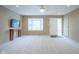 Spacious living room with new carpet, a large window, ceiling fan, and neutral walls at 2807 Westleigh Dr, Indianapolis, IN 46268