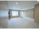 Bright and airy living room features neutral carpet, ample natural light and a ceiling fan at 2807 Westleigh Dr, Indianapolis, IN 46268