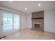 Cozy living room features a brick fireplace and sliding door access to the screened porch at 2807 Westleigh Dr, Indianapolis, IN 46268