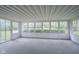 Bright screened-in porch with multiple windows, offering views of the surrounding trees at 2807 Westleigh Dr, Indianapolis, IN 46268