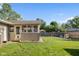 Expansive backyard with well-maintained lawn and enclosed sunroom on house at 2810 Bittersweet Blvd, Columbus, IN 47203