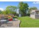 A well-maintained yard with outdoor seating, play equipment, and a storage shed at 2810 Bittersweet Blvd, Columbus, IN 47203