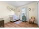 Bright Bedroom features a white crib, decor shelves and charming vintage rocking chair at 2810 Bittersweet Blvd, Columbus, IN 47203