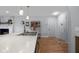 Bright kitchen features a breakfast bar, undermount sink, pendant lights, and new flooring at 2810 Bittersweet Blvd, Columbus, IN 47203