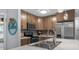 Updated kitchen features stainless appliances, wood cabinets, and modern countertops at 2810 Bittersweet Blvd, Columbus, IN 47203