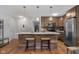Open kitchen with island, bar stool seating, stainless appliances, and a view of the foyer at 2810 Bittersweet Blvd, Columbus, IN 47203