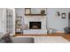 Stylish living room with a decorated fireplace, whitewashed brick, and wood mantle at 2810 Bittersweet Blvd, Columbus, IN 47203