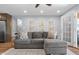 Comfortable living room featuring a modern sectional sofa, stylish wall art, and ample natural light at 2810 Bittersweet Blvd, Columbus, IN 47203