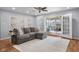 Bright living room with a cozy sectional sofa and direct access to a charming sunroom at 2810 Bittersweet Blvd, Columbus, IN 47203