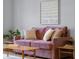 Comfortable living room featuring wood laminate flooring, a couch, and cozy decor at 2810 Bittersweet Blvd, Columbus, IN 47203
