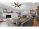 Open living room features a brick fireplace, ceiling fan, and view of the kitchen at 2810 Bittersweet Blvd, Columbus, IN 47203