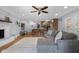 Open living room with a fireplace, ceiling fan, and a seamless connection to the kitchen at 2810 Bittersweet Blvd, Columbus, IN 47203