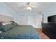 Spacious bedroom with ceiling fan, ample closets, and wood-look flooring at 2810 Bittersweet Blvd, Columbus, IN 47203