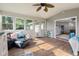Cozy sunroom with wood floors, lots of natural light, comfortable sofa and open doorway at 2810 Bittersweet Blvd, Columbus, IN 47203