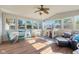 Sunroom featuring a vaulted ceiling, fan, walls of windows, play space, and comfortable seating at 2810 Bittersweet Blvd, Columbus, IN 47203