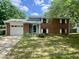 Charming brick home features attached garage and manicured front lawn, creating a welcoming curb appeal at 3023 Fairlawn Dr, Columbus, IN 47203
