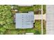 Birds eye view of a home showcasing a patio surrounded by lush greenery and a well-maintained lawn at 3221 Holt St, Whiteland, IN 46184