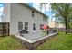 The backyard features a spacious deck with an outdoor seating area and a playhouse at 3221 Holt St, Whiteland, IN 46184