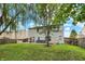 Exterior view of the home, showcasing the backyard, patio, and mature trees at 3221 Holt St, Whiteland, IN 46184