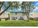 Exterior view of the home, showcasing the backyard, patio, and mature trees at 3221 Holt St, Whiteland, IN 46184