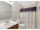 Clean bathroom featuring a vanity with chrome faucet, toilet, and shower/tub with patterned curtain at 3221 Holt St, Whiteland, IN 46184