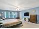 Serene bedroom with natural light, TV, and a cozy chair for relaxation at 3221 Holt St, Whiteland, IN 46184