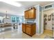 Dining area with a wooden picnic table and a cabinet with a grey countertop, near a door and walk-in pantry at 3221 Holt St, Whiteland, IN 46184