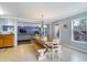 Bright dining area with a wooden table, chairs, natural light, and views into the living room at 3221 Holt St, Whiteland, IN 46184