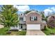 Beautiful two-story home with brick and siding, a well-manicured lawn, and inviting front porch at 3221 Holt St, Whiteland, IN 46184
