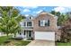 Charming two-story home with a brick and siding exterior, two car garage and a welcoming porch at 3221 Holt St, Whiteland, IN 46184