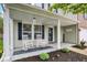 Charming front porch with white rocking chairs, creating a welcoming and relaxing outdoor space at 3221 Holt St, Whiteland, IN 46184