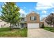 Charming two-story home with brick and siding, manicured lawn, mature tree, and two-car garage at 3221 Holt St, Whiteland, IN 46184