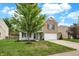 Beautiful two-story home boasts a well-maintained lawn, mature trees, and brick accents create great curb appeal at 3221 Holt St, Whiteland, IN 46184