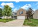 Inviting two-story home with a well-manicured lawn, mature trees, and brick accents creates excellent curb appeal at 3221 Holt St, Whiteland, IN 46184