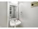 Powder room featuring a white pedestal sink, mirror, and decorative wall hangings at 3221 Holt St, Whiteland, IN 46184