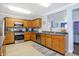 Traditional-style kitchen featuring wood cabinets, stainless steel appliances, and plenty of counter space at 3221 Holt St, Whiteland, IN 46184