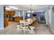 Open kitchen and dining area with wooden cabinets and hardwood floors, flowing into the living room at 3221 Holt St, Whiteland, IN 46184