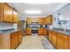 Spacious kitchen features stainless steel appliances, wood cabinetry, and ample counter space at 3221 Holt St, Whiteland, IN 46184