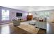 Bright living room with hardwood floors, cozy seating, a piano and a ceiling fan at 3221 Holt St, Whiteland, IN 46184