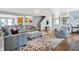 Open living room with hardwood floors, gray seating, an area rug, and a view to other rooms at 3221 Holt St, Whiteland, IN 46184