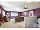 Spacious living room with a projector screen, sofa, armchair, and warm, inviting atmosphere at 3221 Holt St, Whiteland, IN 46184