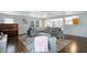 Open living room with large sectional sofa, dark hardwood floors, and a ceiling fan at 3221 Holt St, Whiteland, IN 46184