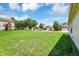 Large, well-maintained backyard with green grass, mature trees, and a glimpse of neighboring homes in a peaceful setting at 3222 Enclave Ln, Greenwood, IN 46143