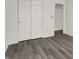 Modern bedroom with sleek gray vinyl floors and a double-door closet for ample storage at 3222 Enclave Ln, Greenwood, IN 46143