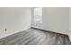 Bright, minimalist bedroom showcasing modern gray vinyl floors and natural light from the window at 3222 Enclave Ln, Greenwood, IN 46143