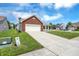 Single-Gathering home with attached garage, long driveway, and well-maintained lawn at 3222 Enclave Ln, Greenwood, IN 46143