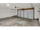 Well-lit garage featuring concrete flooring and garage door at 3222 Enclave Ln, Greenwood, IN 46143