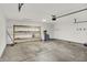 Bright garage space with concrete flooring, convenient storage shelves, and a utility area at 3222 Enclave Ln, Greenwood, IN 46143