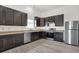 Spacious kitchen with dark wood cabinets, granite countertops, and stainless steel appliances at 3222 Enclave Ln, Greenwood, IN 46143