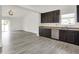 Modern kitchen featuring dark cabinetry, stainless steel appliances, and open floor plan at 3222 Enclave Ln, Greenwood, IN 46143